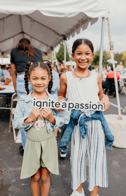 Kids Two kids holding a sign that says ignite a passion