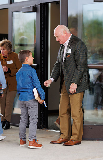Greeting Older man greeting a boy coming into church