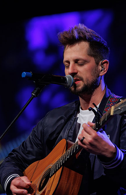 Worship Man playing guitar and singing during worship